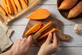 Cooking sweet potato wedges, raw sweet potatoes sliced on cutting board. Royalty Free Stock Photo