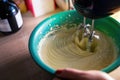 Cooking sweet sponge cake at home - view of a machine whipping liquid cream mascarpone with sugar in plastic bowl at home kitchen