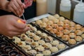 Cooking Takoyaki balls with octopus. Japanese snack for sale