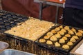 Cooking takoyaki Octopus ball, famous Osaka snack,