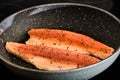 Cooking trout fish on frying pan