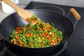 Cooking tasty vegetable mix in wok pan, closeup Royalty Free Stock Photo