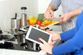 Cooking, technology and home concept - closeup of woman pointing finger to tablet pc computer Royalty Free Stock Photo