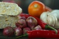 Cooking tempe preparation closeup with onion, garlic, red chili, tomatoes. Seasoned tempeh. Indonesian simple seasoning