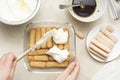 Cooking tiramisu cake with sponge fingers cookies. Step by step recipe. Top view.