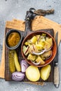 Cooking Traditional German potato salad - Kartoffelsalat. Gray background. Top view