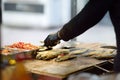 Cooking traditional street food balik in lavash in Istanbul, Turkey. It is grilled mackerel fish in lavash with vegetables and Royalty Free Stock Photo