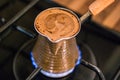 Cooking Turkish Coffee in the kitchen. Royalty Free Stock Photo