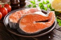 Cooking two fresh raw salmon fish steaks on wooden rustic table Royalty Free Stock Photo