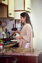 Cooking up something scrumptious for breakfast. a happy young woman cooking breakfast in her kitchen at home.