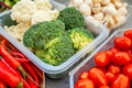 Cooking vegan food with raw vegetables. Broccoli and cauliflower, tomatoes, pepper and champignons for vegetable dishes in a Royalty Free Stock Photo