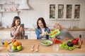 Little girl making video of cooking vegetable salad. Royalty Free Stock Photo