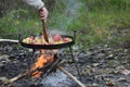 Cooking vegetables on the fire in the forest in autumn Royalty Free Stock Photo