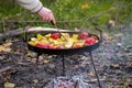 Cooking vegetables on the fire in the forest in autumn Royalty Free Stock Photo