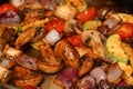 Cooking vegetables in a frying pan - White mushrooms, cherry tomatoes, onions together with zucchini in a cooking pan. Royalty Free Stock Photo