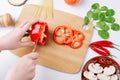 Cooking vegetables, healthy cooking. The process of slicing bell peppers. Mushrooms mushrooms, spinach leaves, chili