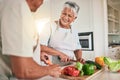 Cooking vegetables, kitchen and senior couple cutting ingredients, prepare food and smile on romantic home date. Health