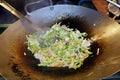 Cooking vegetables in wok for veg chowmein fried veg noodles.