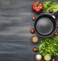 Cooking a vegetarian dinner, red and yellow bell peppers, salad, wooden spoon, cherry tomatoes, condiments,lime, black cooking pot