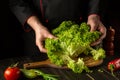 Cooking vegetarian food from Lettuce leaves in the kitchen by the hands of a chef. Vegetarian cuisine