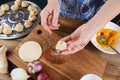 Cooking vegetarian meal. Woman hands making traditional Asian steamed dumplings with pumpkin, onion and ginger