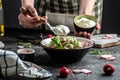 Cooking vegetarian salad of fresh organic radish and green onions dressed with sour cream Royalty Free Stock Photo
