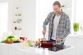 Cooking veggie dish day. Positive man guy prepare tasty family meal morning breakfast frying food pan enjoy wear casual