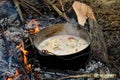 Vegetarian soup cooked in a dixy on a camp fire