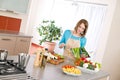 Cooking - Woman reading cookbook in kitchen