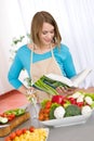 Cooking - Woman reading cookbook in kitchen