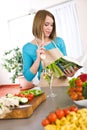 Cooking - Woman reading cookbook in kitchen