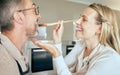 Cooking woman feed man to taste food, meal and lunch in kitchen at home. Happy, smile and care wife giving, hungry and Royalty Free Stock Photo