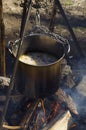 Cooking at the wood over campfire. Casserole with rice and meat