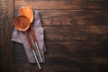 Cooking wooden utensils, basil leaves and spices on old wooden background. Abstract food background. Top view of dark rustic kitch Royalty Free Stock Photo