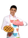 Cooking. Young man in apron baked tasty pie