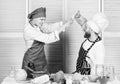 Cooking with your spouse can strengthen relationships. Couple compete in culinary arts. Woman and bearded man culinary