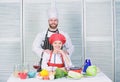 Cooking with your spouse can strengthen relationships. Woman and bearded man culinary partners. Ultimate cooking