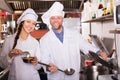 Cooks greeting customers at bistro