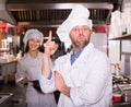 Cooks greeting customers at bistro