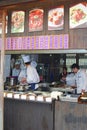 Cooks are preparing meals in a take away restaurant in water town Wuzhen, China