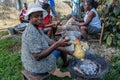 Cooks at a rural parish prepare fresh chicken for a meal during a medical mission to Haiti.