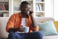 Cool african american man drinking coffee and talking on phone Royalty Free Stock Photo