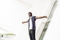 Cool African American man portrait in the city with music headphones and smiling, positive attitude Royalty Free Stock Photo