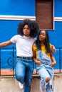 Cool african couple embracing from the shoulder leaning on railing Royalty Free Stock Photo