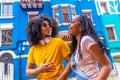 Cool african couple laughing talking in a colorful street Royalty Free Stock Photo