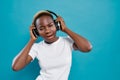 Cool african girl in white shirt listening music in studio Royalty Free Stock Photo