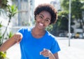 Cool african woman in a blue shirt outdoor in the city Royalty Free Stock Photo