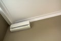 Cool air conditioner installed in room interior on white ceiling and light walls copy space background. Climate control, Royalty Free Stock Photo