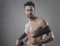 Cool athletic man posing with towel