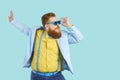 Cool bearded fat man in colorful stylish clothes and sunglasses is having fun and enjoying disco. Royalty Free Stock Photo